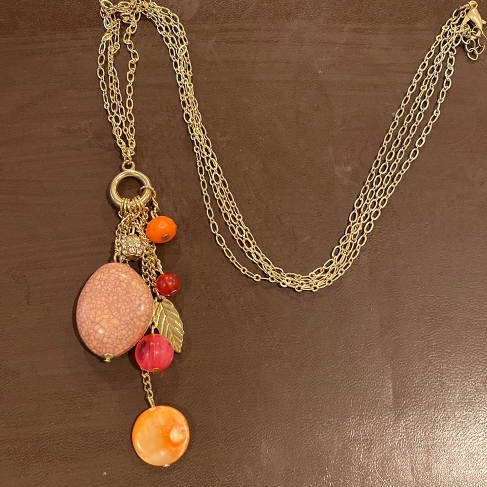 26 inch double gold chain with a hanging pendant of several stones